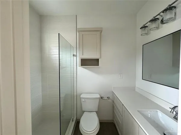 a white toilet sitting next to a bathroom sink