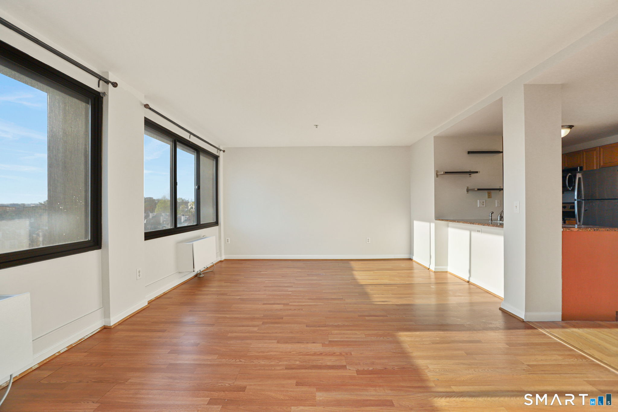 300 Broad Street, Unit 603 Stamford, CT 06901 - Photo 11 of 20 a view of an empty room with wooden floor and a window