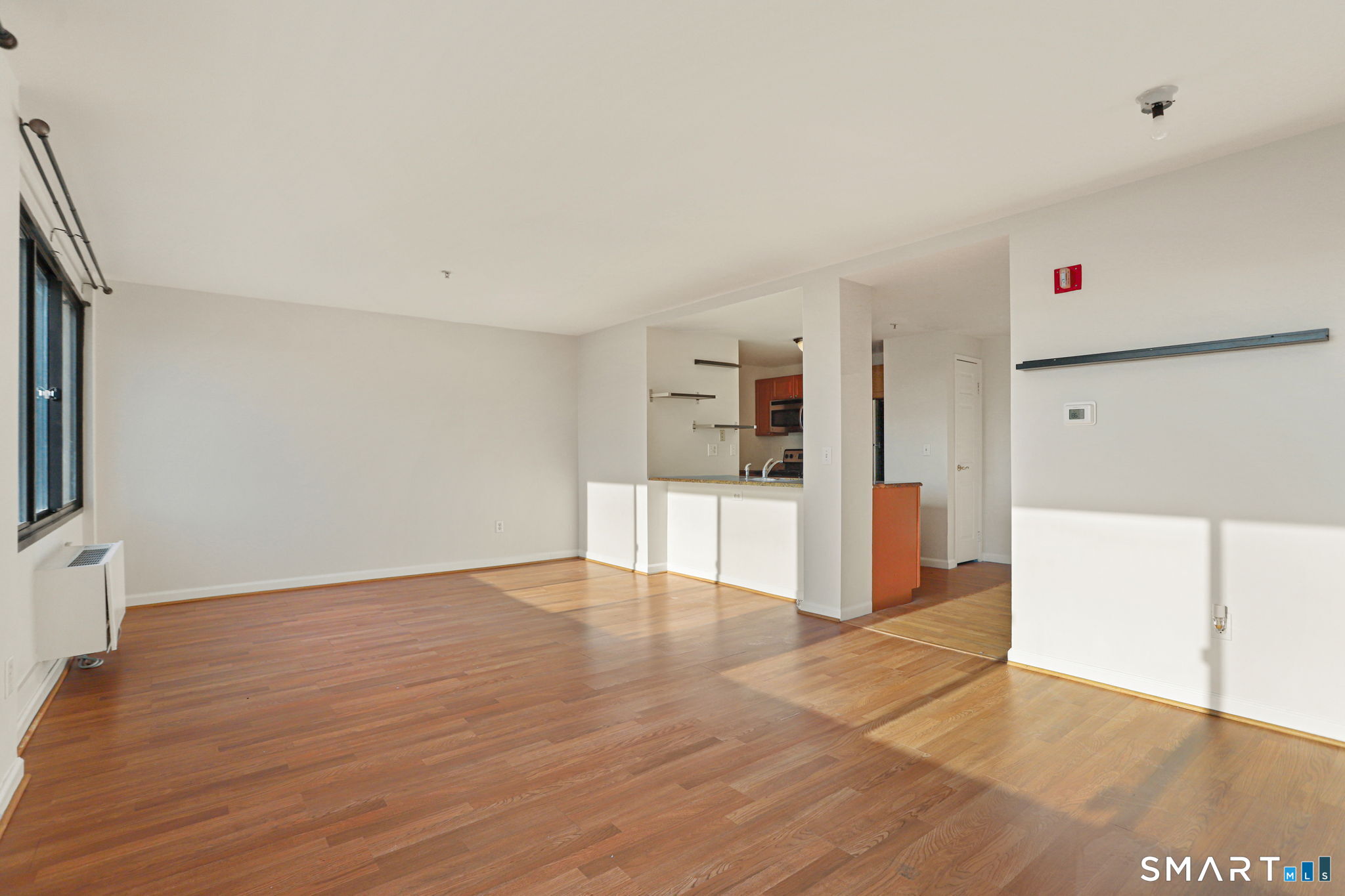 300 Broad Street, Unit 603 Stamford, CT 06901 - Photo 12 of 20 a view of a kitchen with wooden floor and a refrigerator