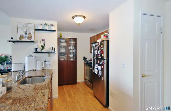 a kitchen with stainless steel appliances granite countertop a refrigerator and sink