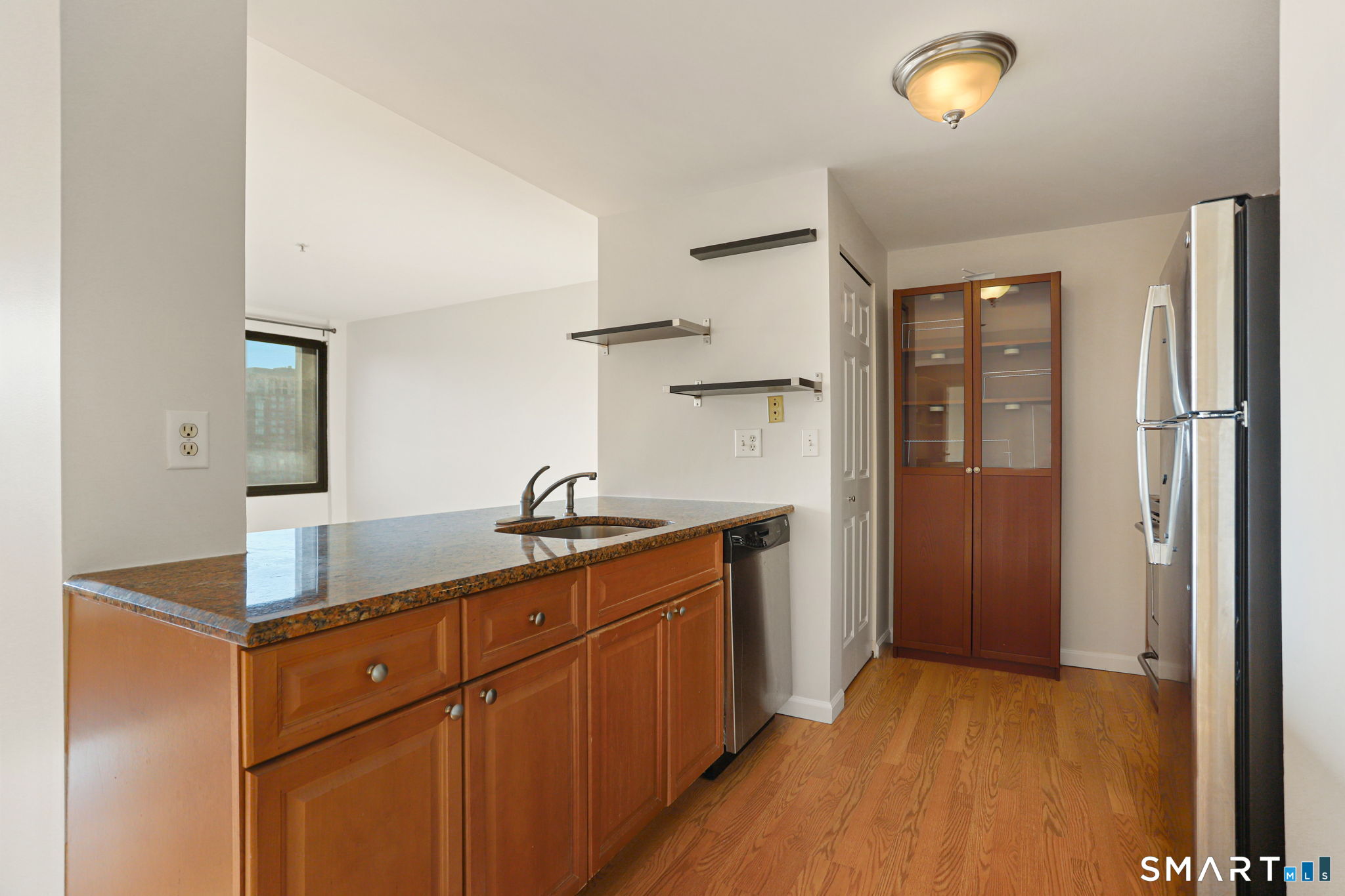 300 Broad Street, Unit 603 Stamford, CT 06901 - Photo 4 of 20 a kitchen with stainless steel appliances granite countertop a sink stove and refrigerator