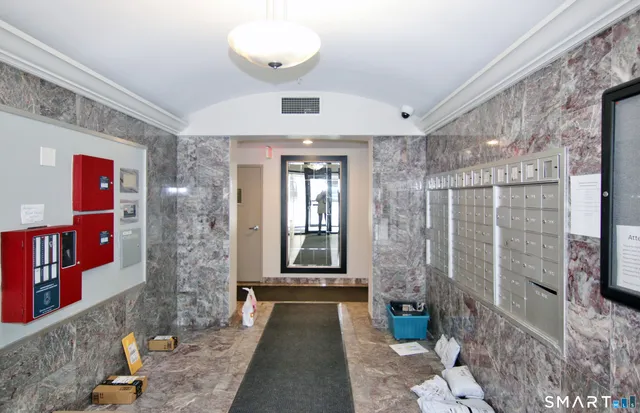 a view of a hallway with brick walls