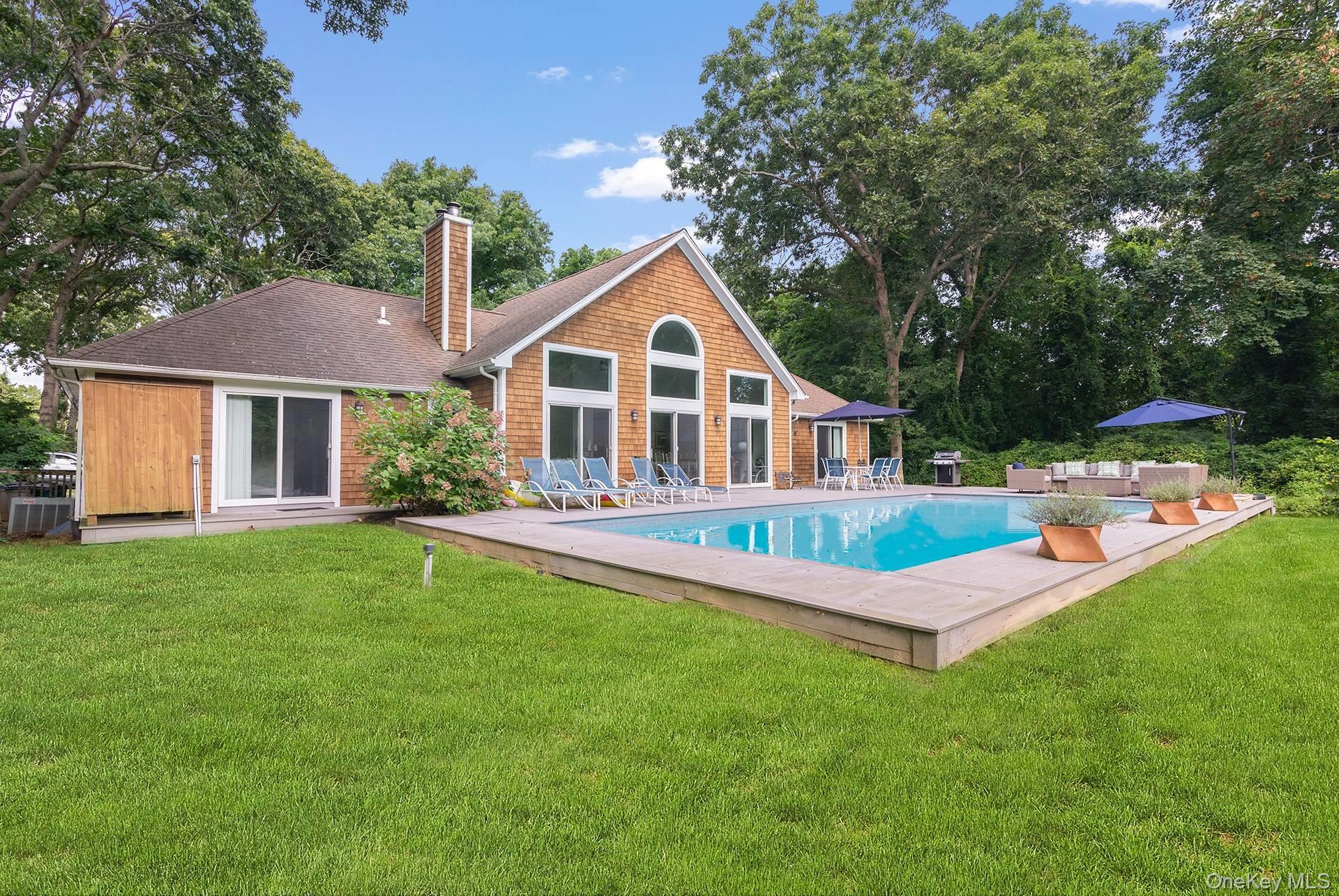 20 Cutter Court East Hampton, NY 11937 - Photo 2 of 18 a front view of a house with a yard and trees