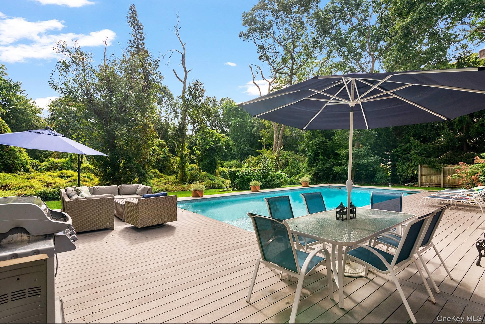 20 Cutter Court East Hampton, NY 11937 - Photo 3 of 18 a view of patio with table and chairs under an umbrella