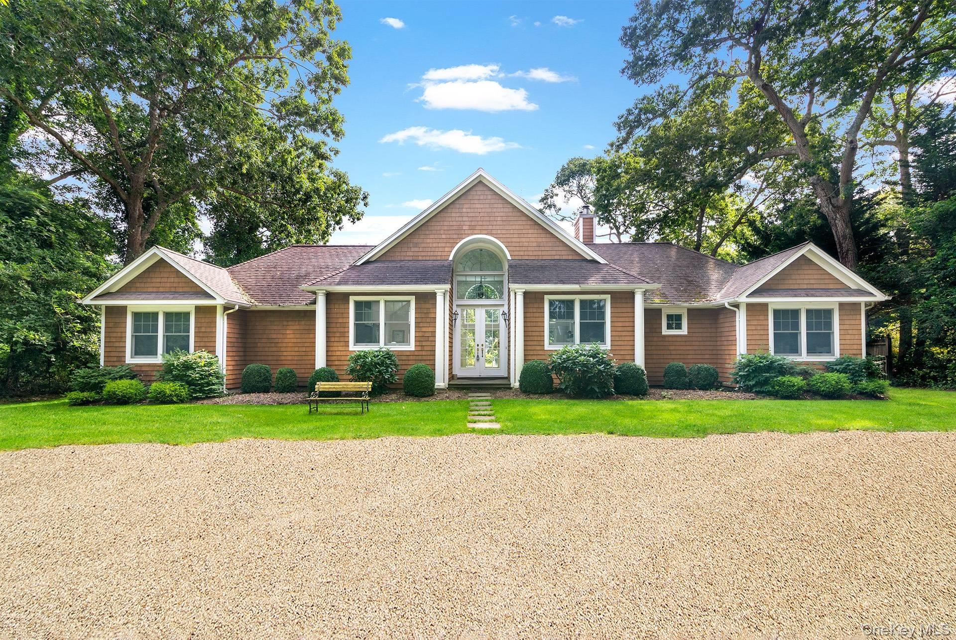 20 Cutter Court East Hampton, NY 11937 - Photo 4 of 18 a front view of a house with a yard and garage