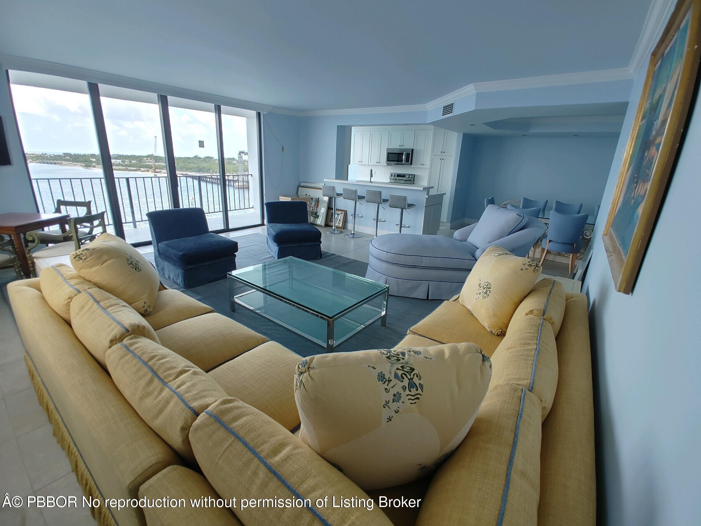 3800 Washington Road, Unit 907 West Palm Beach, FL 33405 - Photo 1 of 8 a living room with furniture and a large window
