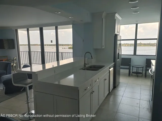 a kitchen with a table chairs and a sink