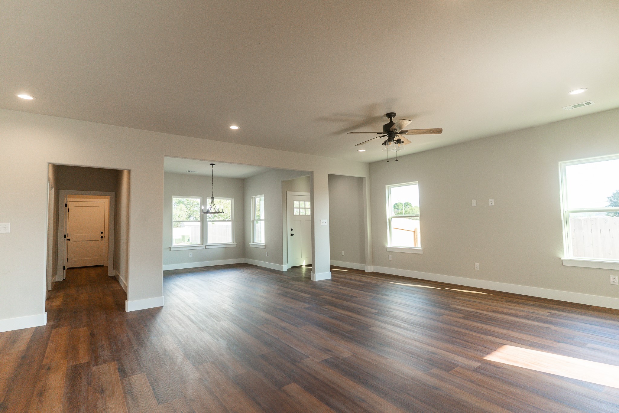 305 String Prairie Way Smithville, TX 78957 - Photo 9 of 26 wooden floor in an empty room with a window