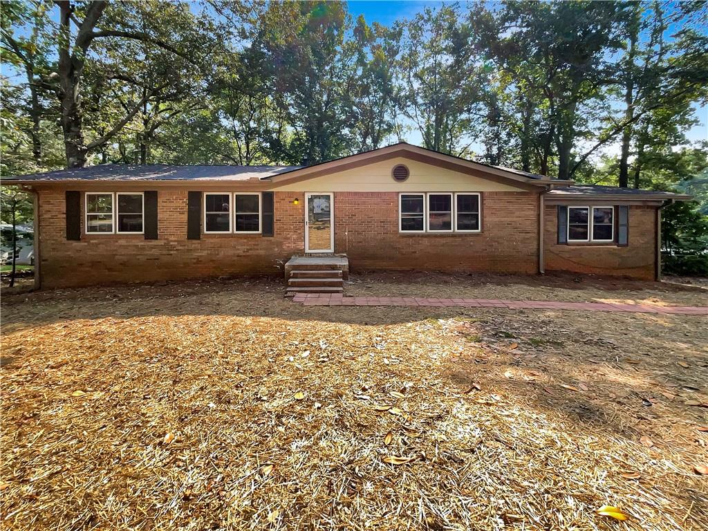 4140 Jailette Road Southwest Atlanta, GA 30349 - Photo 1 of 1 a house that has a tree in front of it