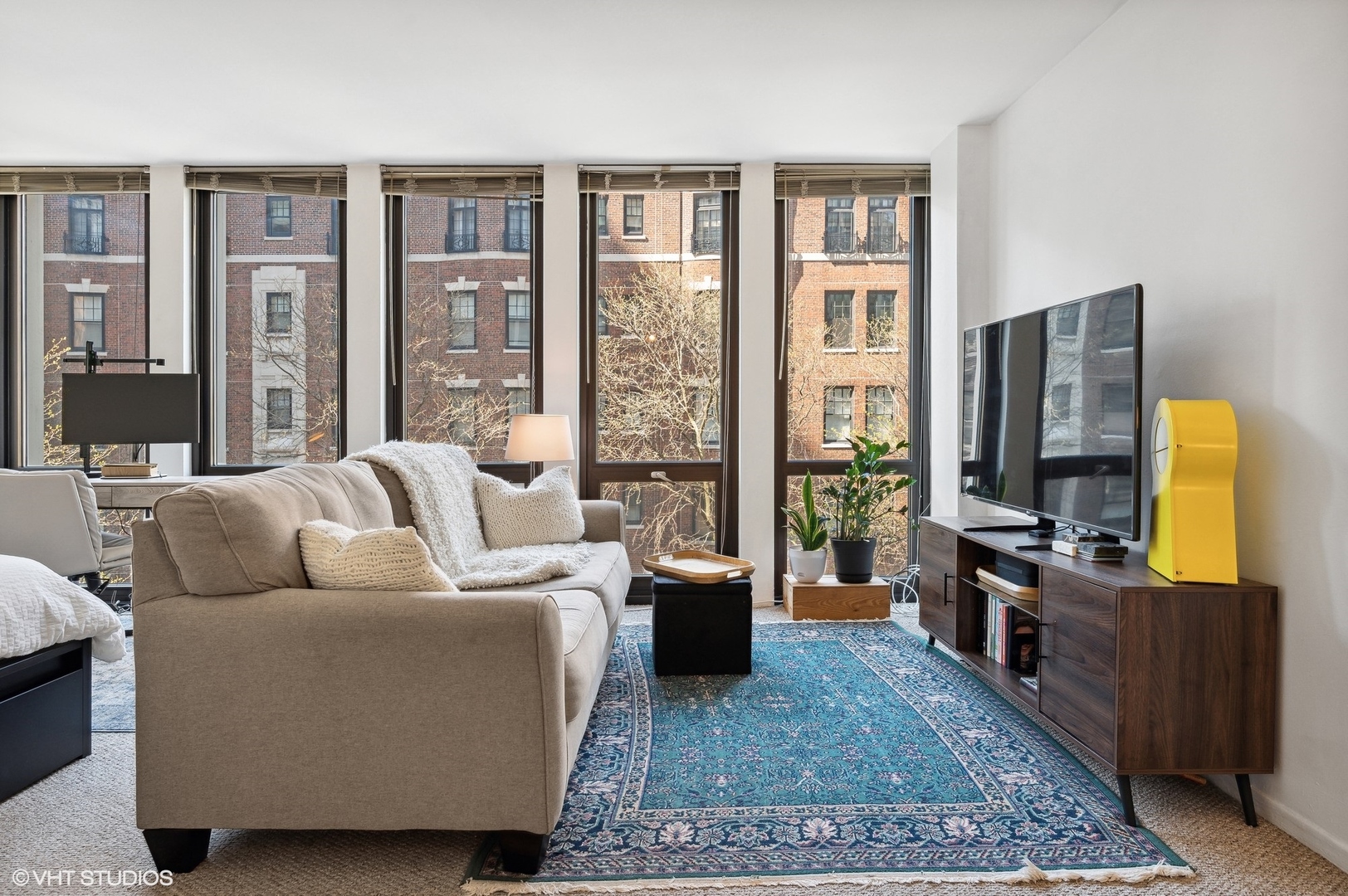 1 East Scott Street, Unit 601 Chicago, IL 60610 - Photo 3 of 15 a living room with furniture a rug a flat screen tv and a floor to ceiling window