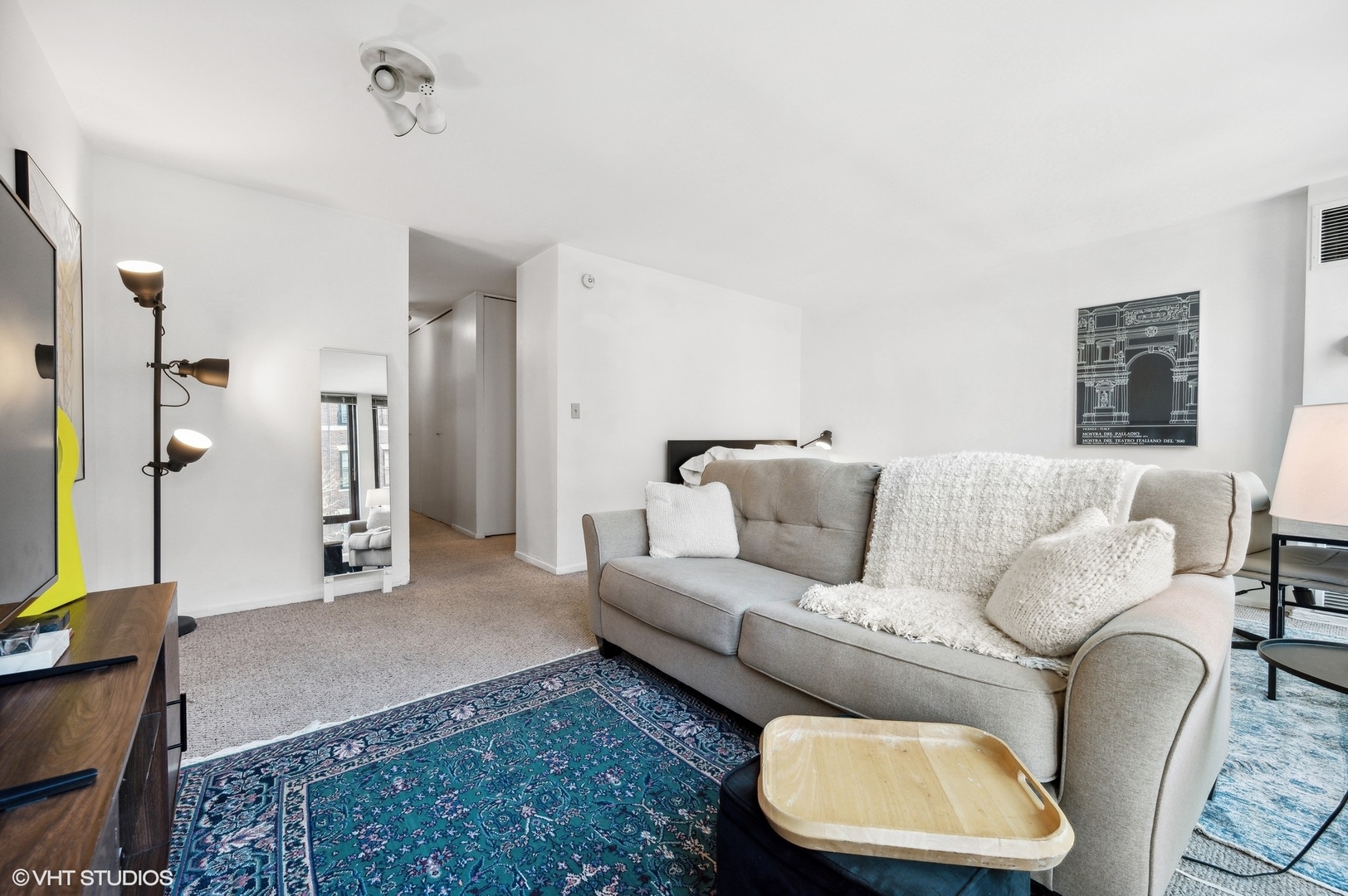 1 East Scott Street, Unit 601 Chicago, IL 60610 - Photo 4 of 15 a living room with a couch and a flat screen tv