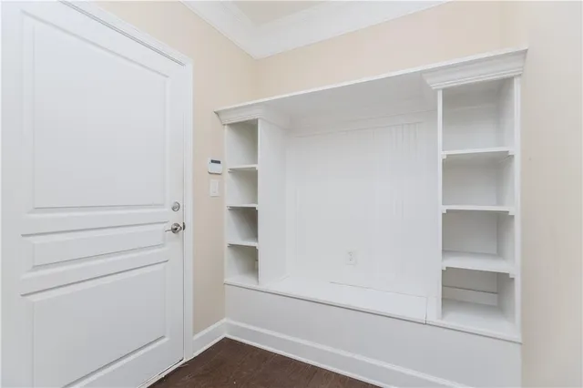 a view of walk in closet with empty racks