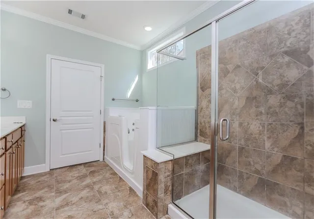a bathroom with a bathtub and a shower