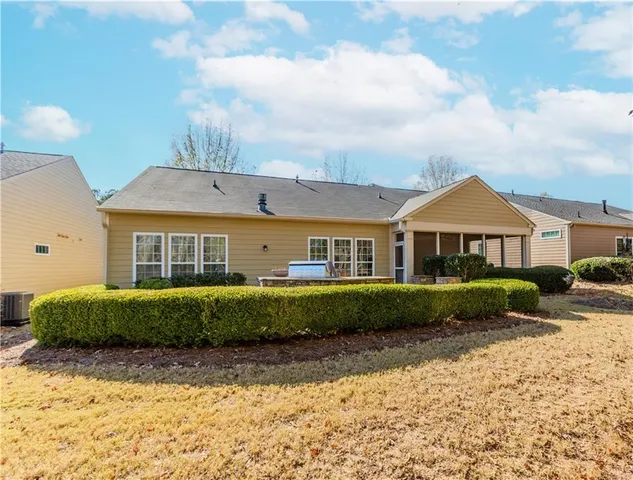 a front view of a residential apartment building with a yard