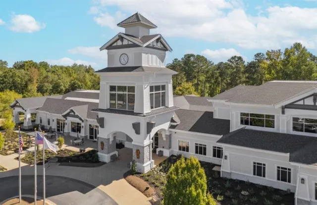a backyard of a house with swimming pool and lake view