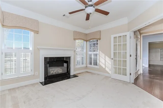 a view of a livingroom with a fireplace and window