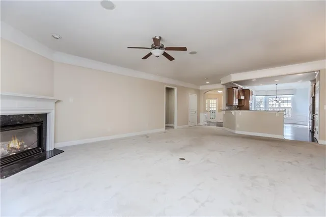 a view of a livingroom with a fireplace and a window