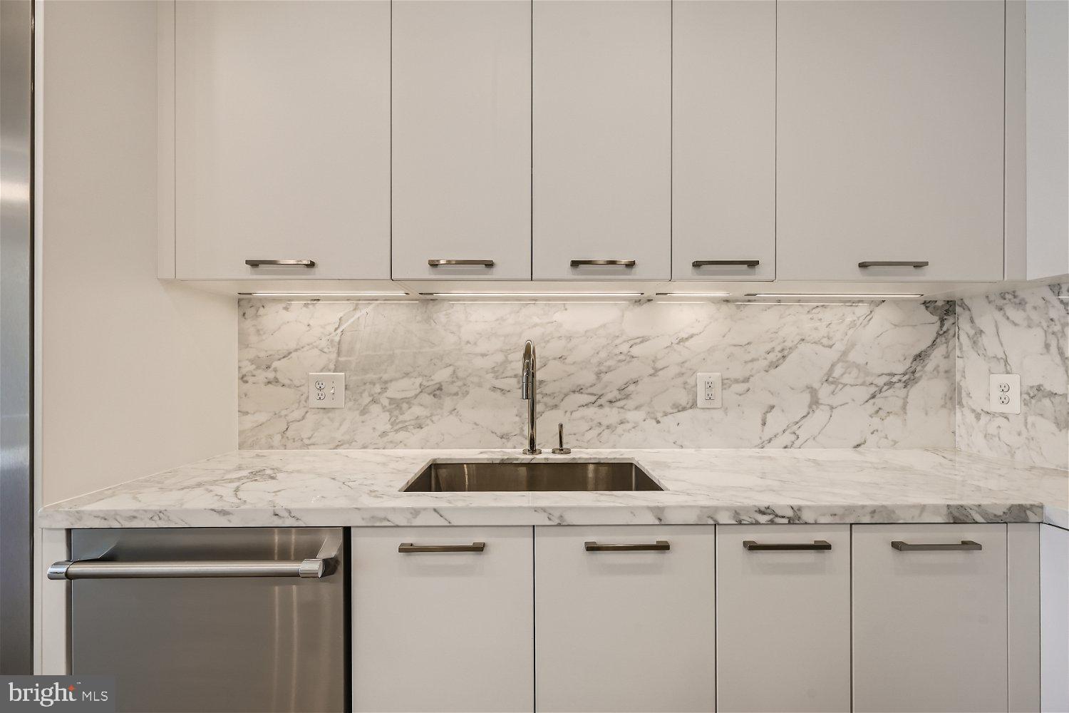 1330 Lancaster Street, Unit C302 Baltimore, MD 21231 - Photo 11 of 41 a sink with granite countertop white cabinets and a granite counter top