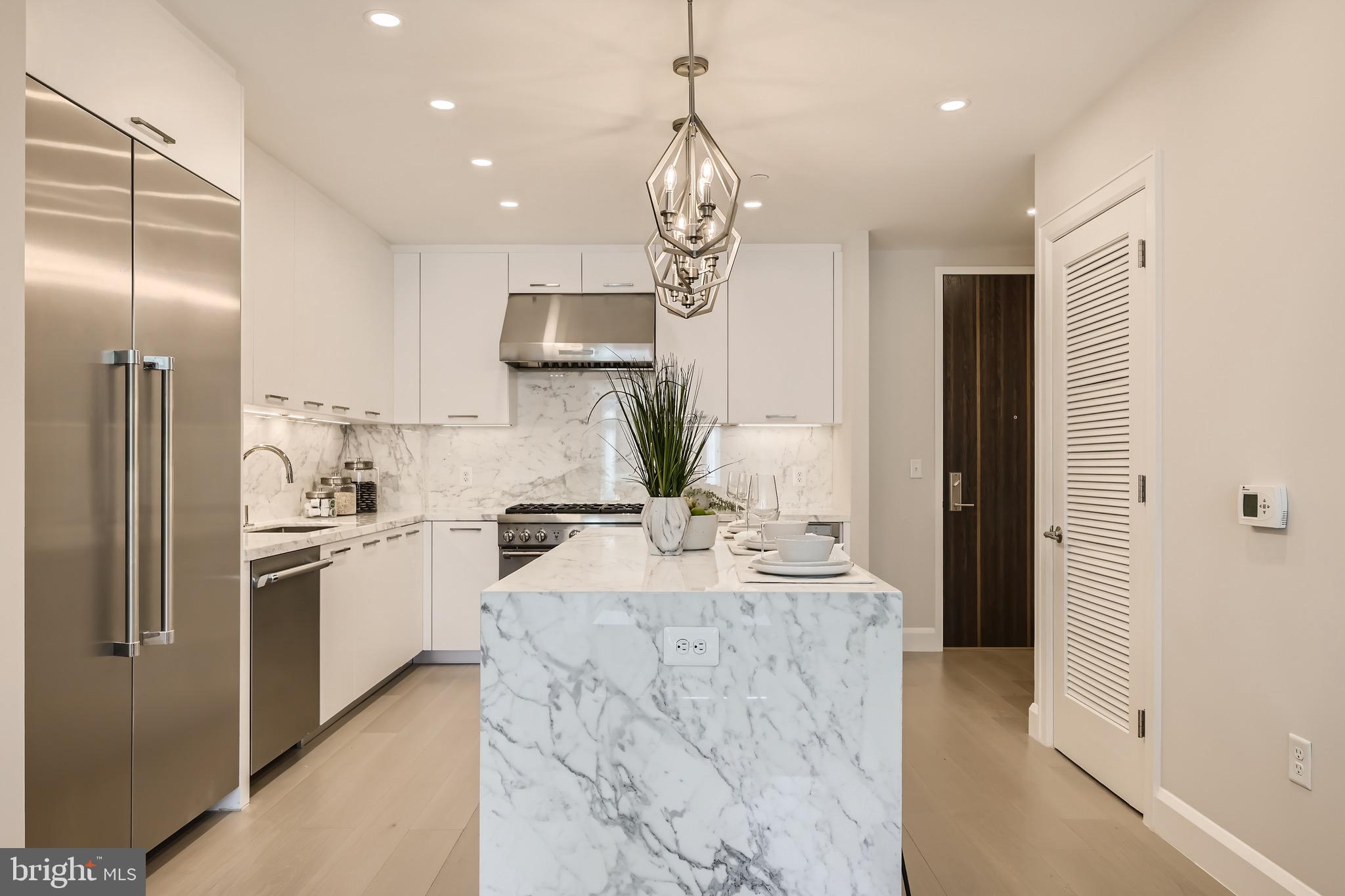 1330 Lancaster Street, Unit C302 Baltimore, MD 21231 - Photo 12 of 41 a kitchen with stainless steel appliances a sink stove and refrigerator
