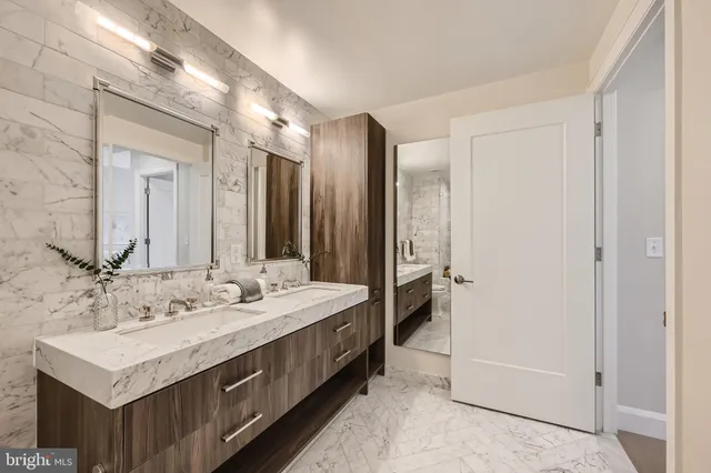 a bathroom with a double vanity sink mirror and double
