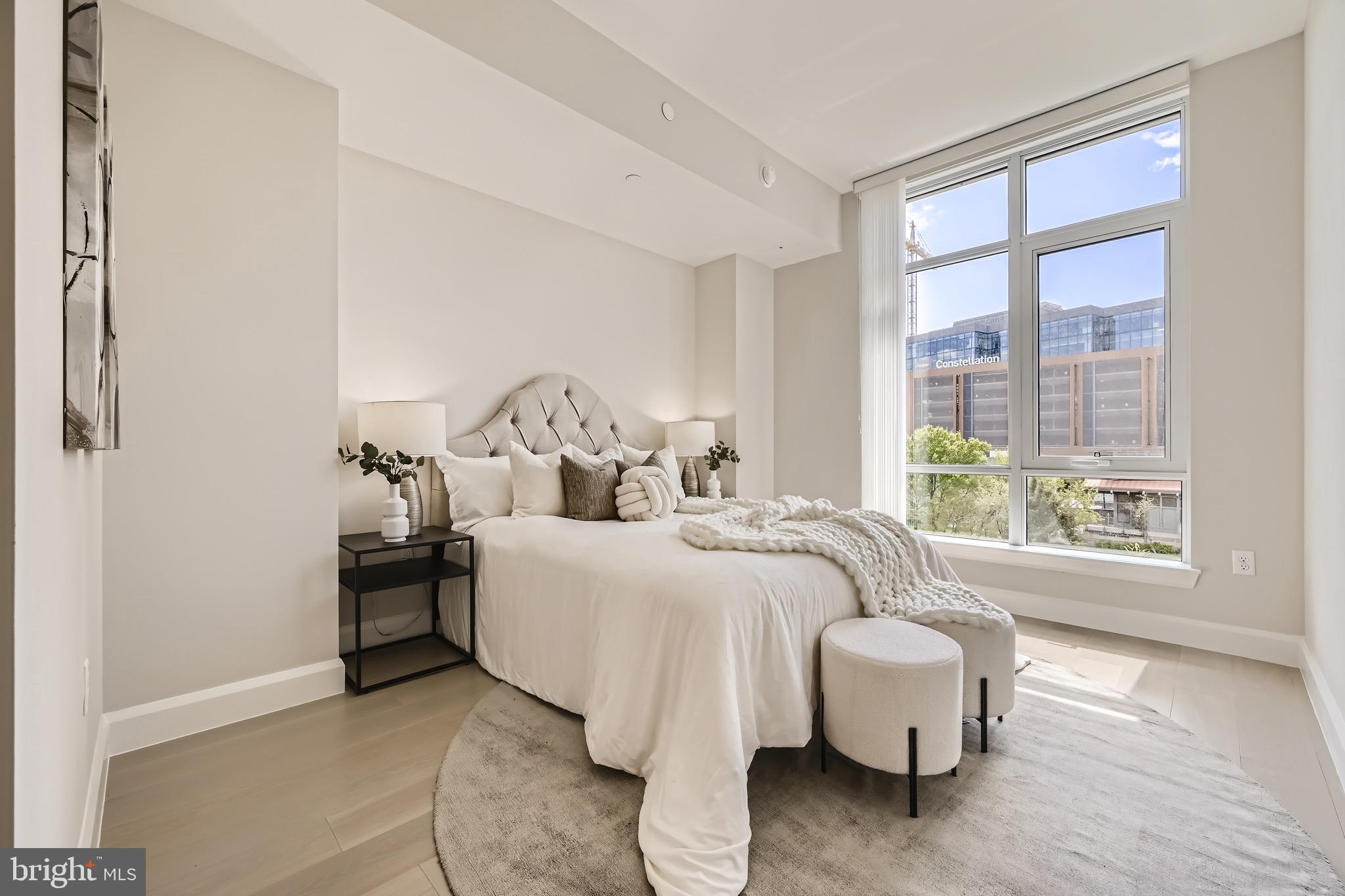 1330 Lancaster Street, Unit C302 Baltimore, MD 21231 - Photo 17 of 41 a bed room with a bed and a large window