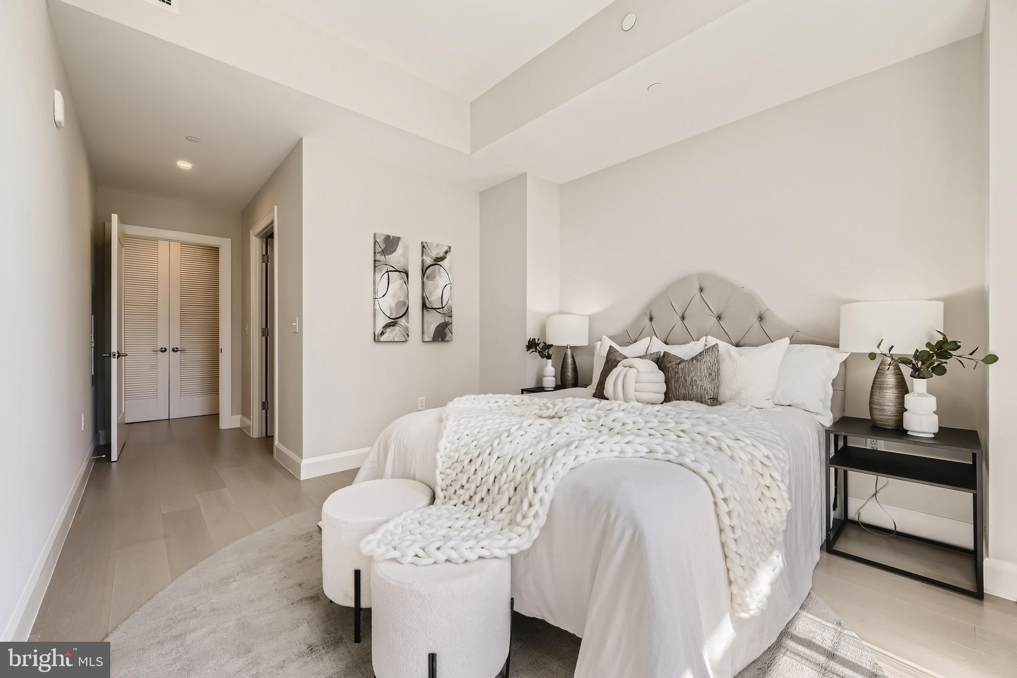 1330 Lancaster Street, Unit C302 Baltimore, MD 21231 - Photo 19 of 41 a spacious bedroom with a bed and a view of bathroom