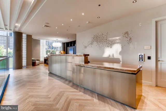 a large kitchen with stainless steel appliances lots of counter space and wooden floor