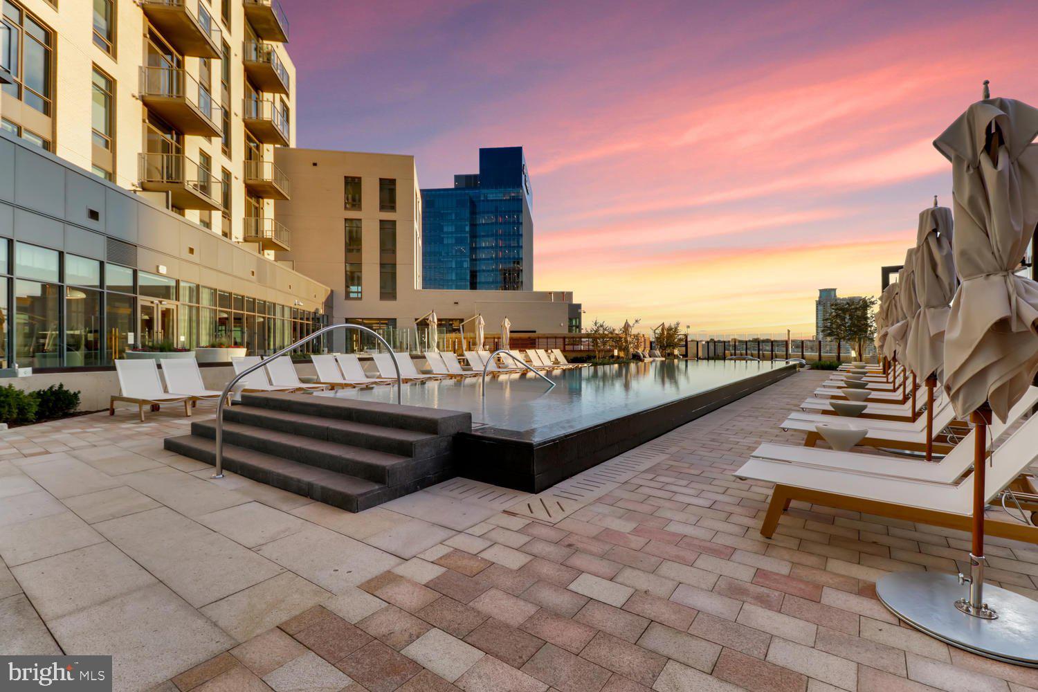 1330 Lancaster Street, Unit C302 Baltimore, MD 21231 - Photo 32 of 41 a swimming pool with outdoor seating and buildings