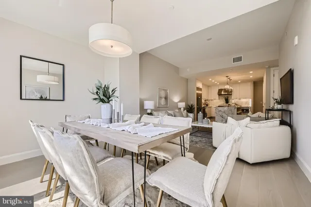 a view of a dining room with furniture and wooden floor