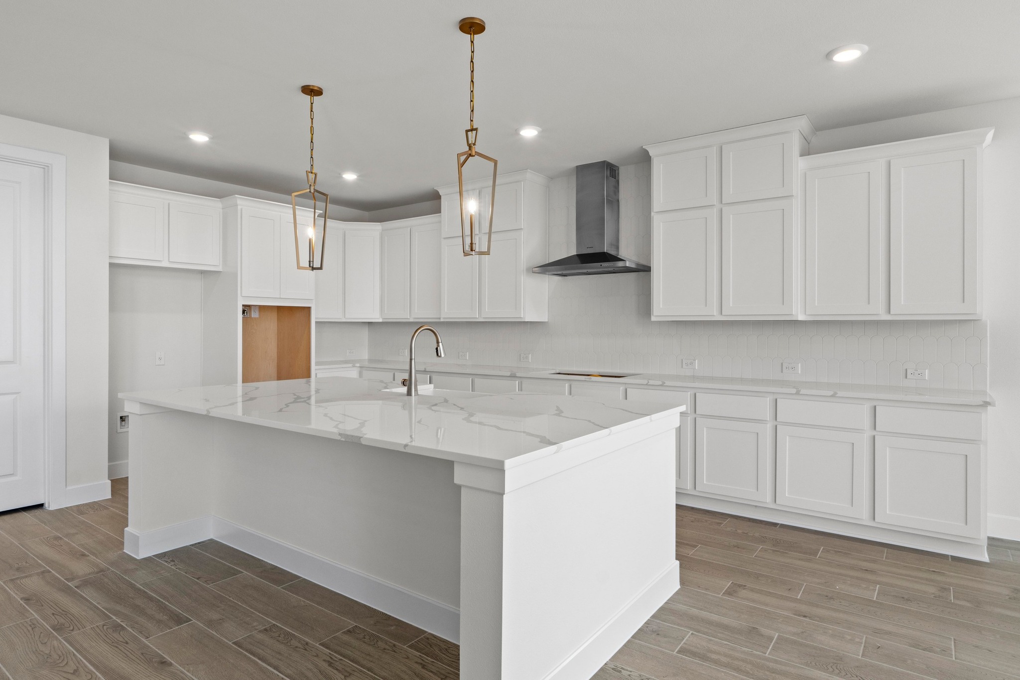 604 Lightstone Drive Georgetown, TX 78633 - Photo 5 of 39 a kitchen with kitchen island a sink stainless steel appliances and cabinets
