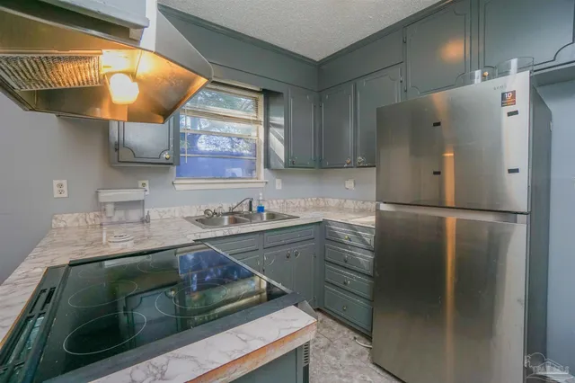 a kitchen with stainless steel appliances granite countertop a refrigerator and a sink
