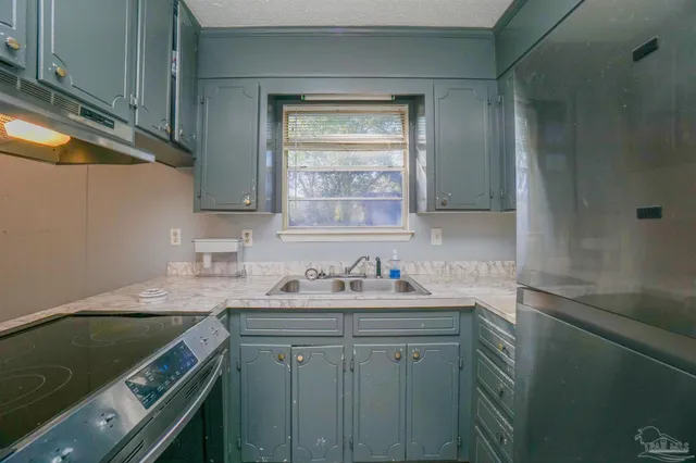 a kitchen with a sink cabinets and a window