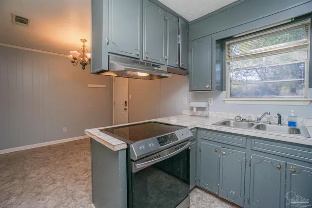 a utility room with sink dryer and washer