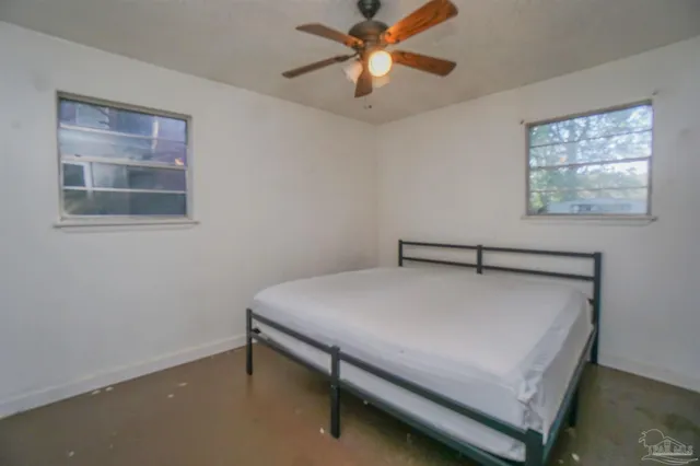 a bed sitting in a room next to a window