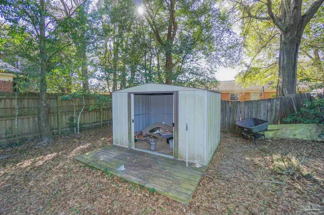 a backyard of a house with bicycles parked and swing
