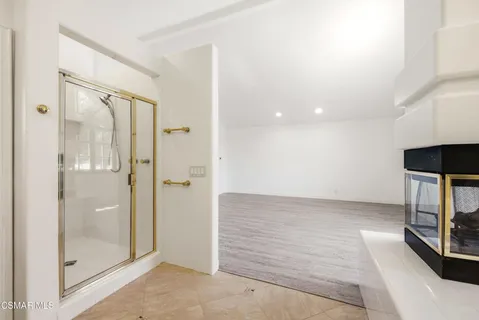 a view of an empty room with a mirror