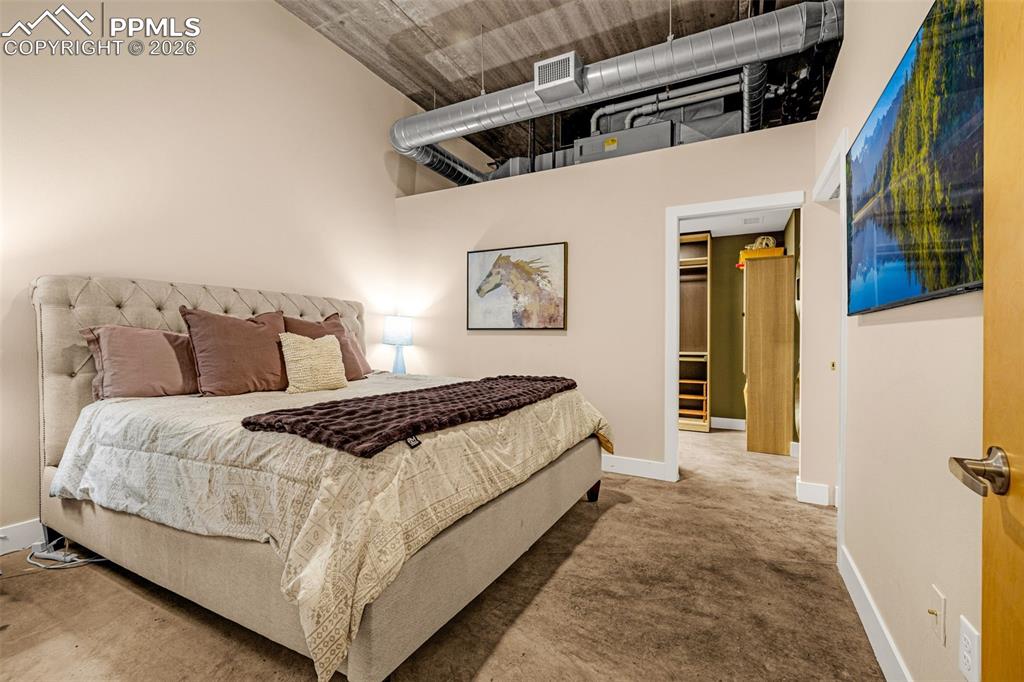 101 North Tejon Street, Unit 280 Colorado Springs, CO 80903 - Photo 15 of 32 a bedroom with a bed and walk in closet