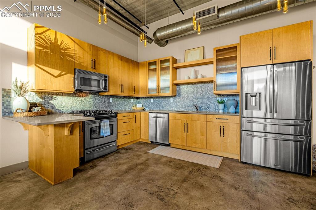 101 North Tejon Street, Unit 280 Colorado Springs, CO 80903 - Photo 6 of 32 a kitchen with stainless steel appliances granite countertop a stove a sink and a refrigerator