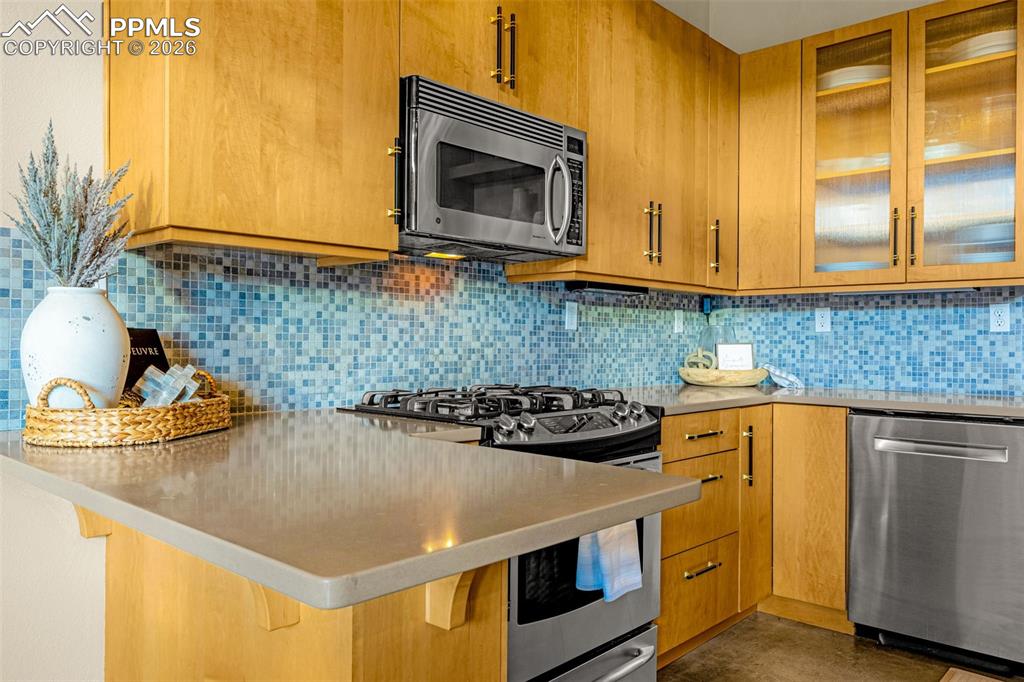 101 North Tejon Street, Unit 280 Colorado Springs, CO 80903 - Photo 7 of 32 a kitchen with a sink a stove and cabinets