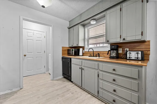 a kitchen with cabinets appliances and a window