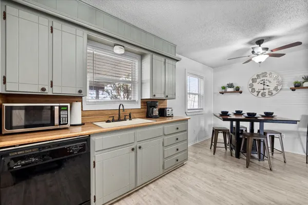a kitchen with a stove a sink and a microwave
