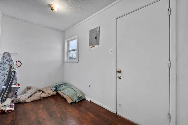 a room with a bed and wooden floor