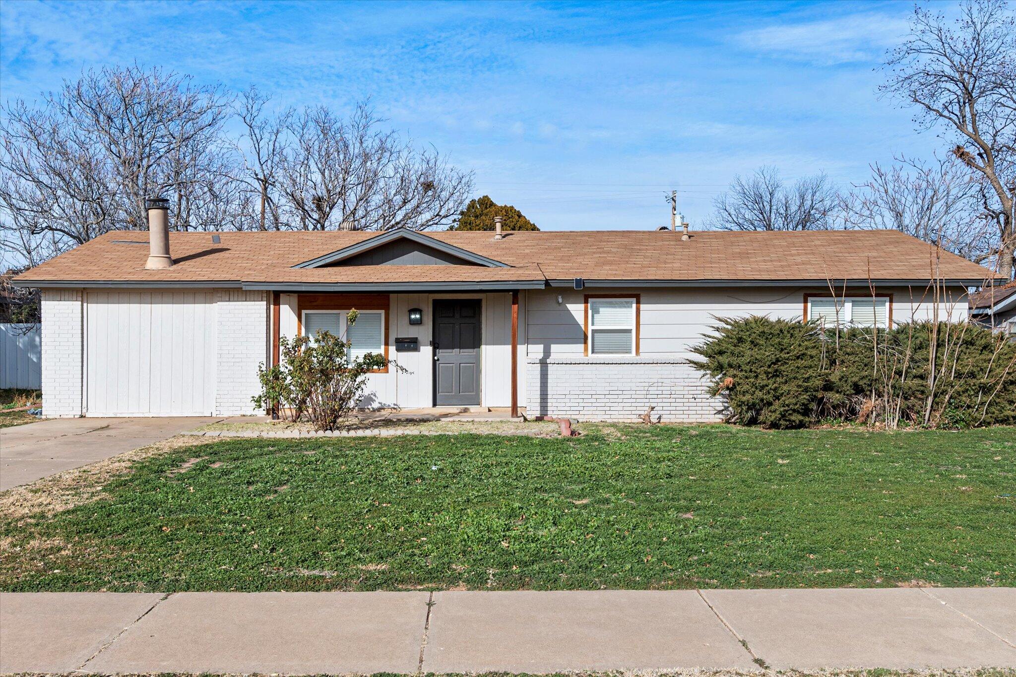 4824 8th Street Lubbock, TX 79416 - Photo 2 of 27 a front view of a house with a yard