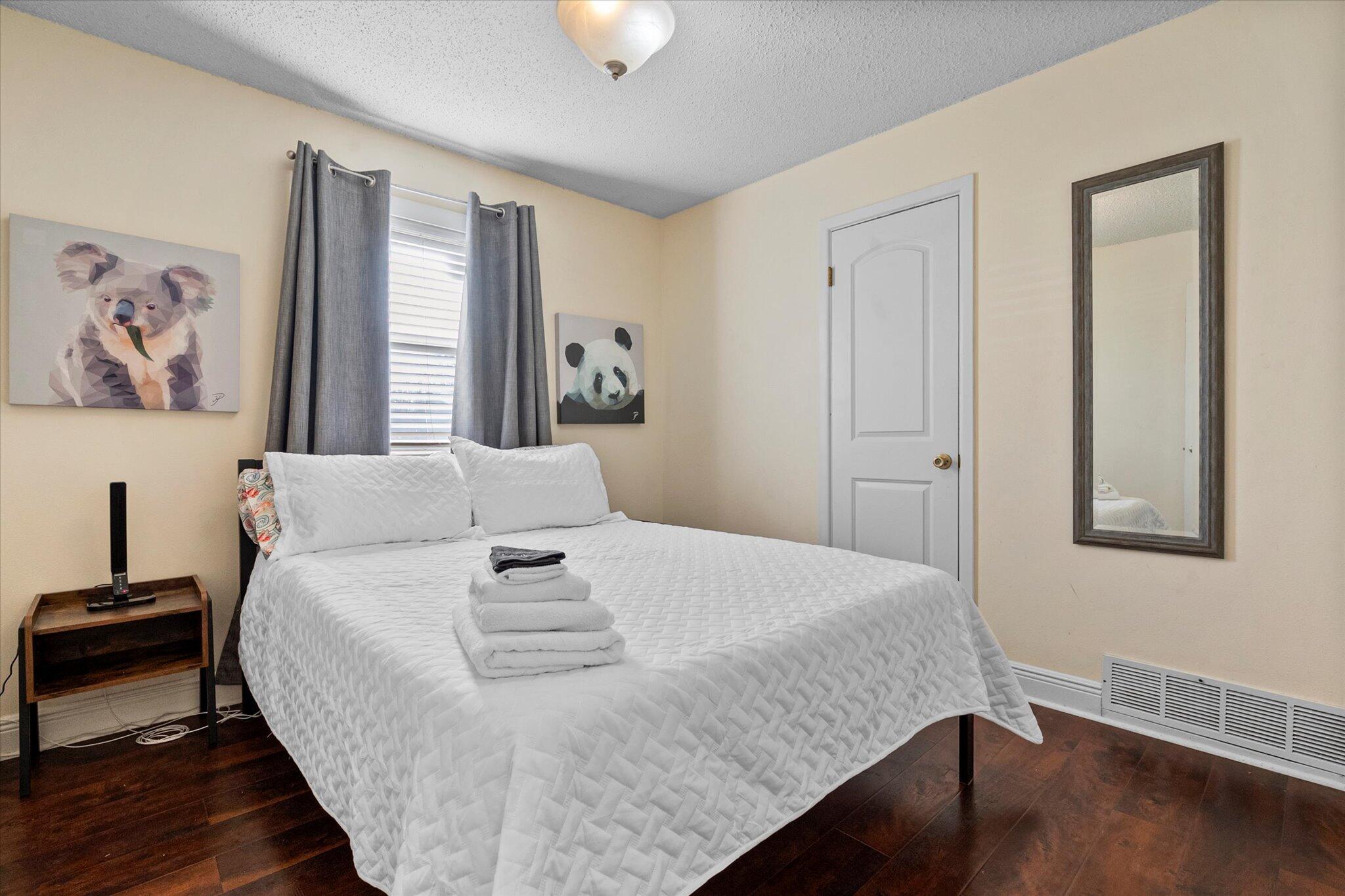 4824 8th Street Lubbock, TX 79416 - Photo 21 of 27 a bedroom with a bed and wooden floor