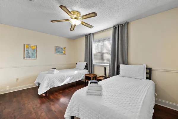 a bedroom with two beds and a large window