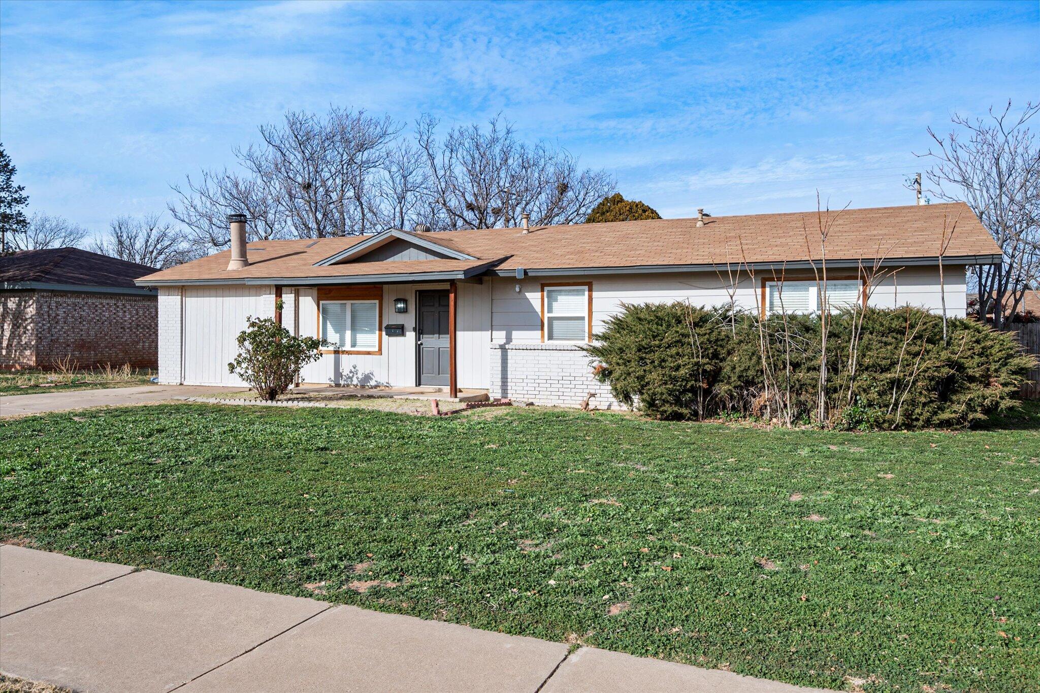 4824 8th Street Lubbock, TX 79416 - Photo 3 of 27 a front view of a house with garden