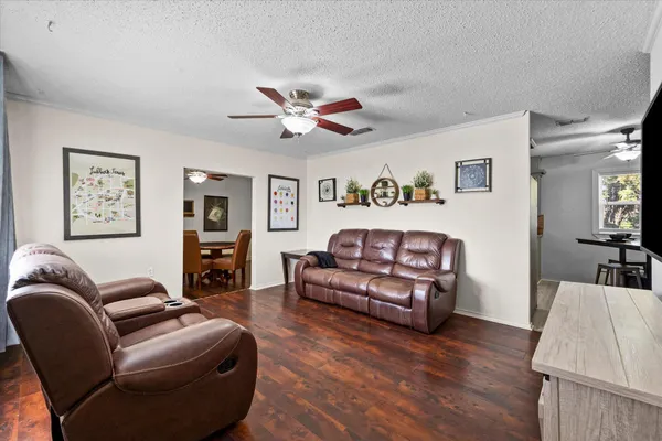 a living room with furniture and wooden floor