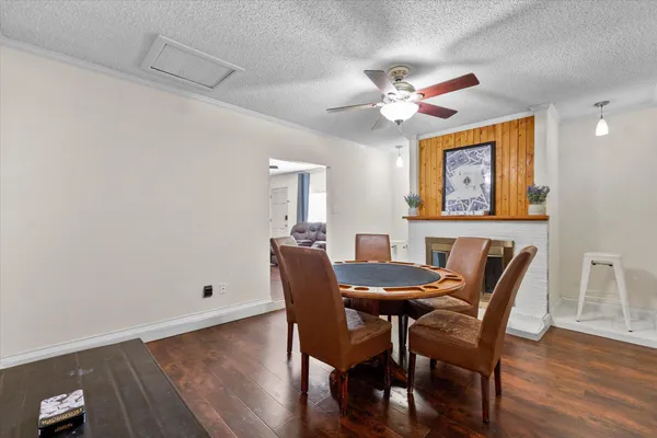 a view of a dining room with furniture and wooden floor