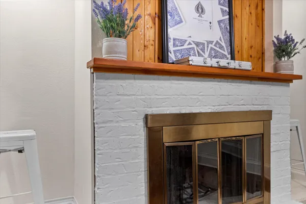 a fireplace with a potted plant on the wall