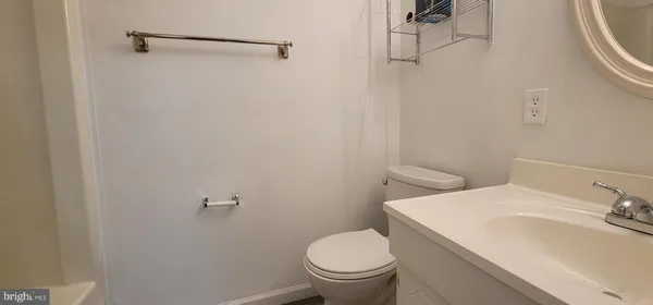 a white toilet sitting next to a bathroom sink